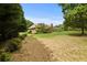 Expansive backyard featuring a lush lawn, mature trees, and potential for outdoor activities and relaxation at 2139 Bramlett Nw Pl, Marietta, GA 30064