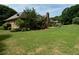 Spacious backyard with lush green grass, mature trees, and a charming deck area for outdoor entertaining at 2139 Bramlett Nw Pl, Marietta, GA 30064