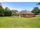 Beautiful backyard with a well-manicured lawn, mature trees, and a brick home providing a charming backdrop at 2139 Bramlett Nw Pl, Marietta, GA 30064