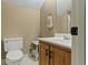 Well-lit half bathroom featuring a vanity and toilet at 2139 Bramlett Nw Pl, Marietta, GA 30064