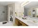 Bright bathroom featuring double sink vanity, large mirror, and glass door shower at 2139 Bramlett Nw Pl, Marietta, GA 30064