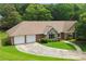 Charming brick home featuring a two-car garage, well-maintained lawn, and a welcoming entrance at 2139 Bramlett Nw Pl, Marietta, GA 30064