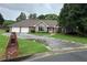 Inviting single-story home with a stone exterior accent, a two-car garage, and a well-maintained front lawn at 2139 Bramlett Nw Pl, Marietta, GA 30064