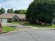 Attractive single-story home boasts a stone facade, a two-car garage, and a manicured front yard with mature trees at 2139 Bramlett Nw Pl, Marietta, GA 30064