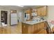 Spacious kitchen with hardwood floors, center island, wooden cabinetry, and modern appliances at 2139 Bramlett Nw Pl, Marietta, GA 30064