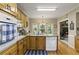 Sunlit kitchen with wooden cabinets, granite countertops, stainless steel appliances, and adjacent dining area at 2139 Bramlett Nw Pl, Marietta, GA 30064