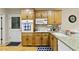 Bright kitchen area featuring wooden cabinets, tile backsplash, granite counters, and stainless steel appliances at 2139 Bramlett Nw Pl, Marietta, GA 30064