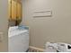 Functional laundry room with white washer and dryer, ample storage, and a cute 'Laundry Room' sign at 2139 Bramlett Nw Pl, Marietta, GA 30064