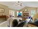 Open living room featuring a brick fireplace, vaulted ceiling, and seamless dining room access at 2139 Bramlett Nw Pl, Marietta, GA 30064