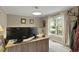 Bright home office featuring a wooden desk, dual monitors, and natural light from the large window at 2139 Bramlett Nw Pl, Marietta, GA 30064