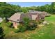 Expansive backyard showcasing lush landscaping, a stone patio, and a well-maintained brick house with a rear deck at 2139 Bramlett Nw Pl, Marietta, GA 30064