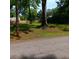 Street view of a lot with mature trees, offering a serene and private setting for building your dream home at 2637 Johnson St, Lithonia, GA 30058