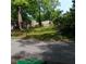 Street view of a grassy lot with mature trees, offering a serene and private setting for building your dream home at 2637 Johnson St, Lithonia, GA 30058