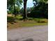 Street view of a lot with mature trees, offering a serene and private setting for building your dream home at 2637 Johnson St, Lithonia, GA 30058