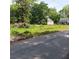 Street view of vacant lot offering potential for new construction in established neighborhood with mature trees at 2637 Johnson St, Lithonia, GA 30058