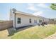 Spacious backyard with healthy lawn, wooden fence, and patio seating area at 3715 Bridges Ct, Cumming, GA 30040