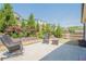 Landscaped backyard with lush greenery, a patio, and outdoor seating at 3715 Bridges Ct, Cumming, GA 30040