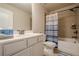 Well lit bathroom featuring a shower and bathtub combination, a toilet, and a vanity with white cabinets at 3715 Bridges Ct, Cumming, GA 30040