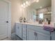 Well-lit bathroom featuring double vanity with modern fixtures and a large mirror at 3715 Bridges Ct, Cumming, GA 30040