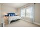 Comfortable bedroom with a large window, plush carpet and a blue-themed decor at 3715 Bridges Ct, Cumming, GA 30040
