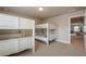 Cozy bedroom featuring carpeted floors and two sets of white painted bunk beds at 3715 Bridges Ct, Cumming, GA 30040