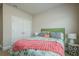 Bedroom featuring a cozy bed, side table with lamp and a closet at 3715 Bridges Ct, Cumming, GA 30040