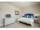 Cozy bedroom with a bed, dresser, and a side table with lamp at 3715 Bridges Ct, Cumming, GA 30040