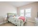 Comfortable bedroom featuring a bed, side tables, and natural light from windows at 3715 Bridges Ct, Cumming, GA 30040
