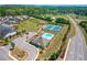 Aerial view of community pool and tennis courts near residential area at 3715 Bridges Ct, Cumming, GA 30040