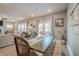Open-concept dining area with seating for six with modern lighting and access to the patio at 3715 Bridges Ct, Cumming, GA 30040