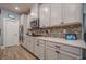 Bright kitchen features white cabinetry, modern appliances, quartz countertops, and stylish backsplash at 3715 Bridges Ct, Cumming, GA 30040