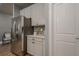 Modern kitchen featuring stainless steel appliances, white cabinetry, and stylish backsplash details at 3715 Bridges Ct, Cumming, GA 30040