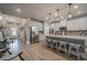 Open kitchen with a large island, pendant lighting, stainless steel appliances, and hardwood floors at 3715 Bridges Ct, Cumming, GA 30040