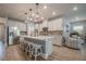 Spacious open kitchen featuring a large island with seating, stainless steel appliances, and modern lighting at 3715 Bridges Ct, Cumming, GA 30040
