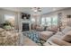 Spacious living room with fireplace, ceiling fan, and plenty of natural light at 3715 Bridges Ct, Cumming, GA 30040