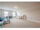 Spacious carpeted playroom or bonus room with natural light and plenty of space for activities at 3715 Bridges Ct, Cumming, GA 30040