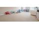 Spacious carpeted playroom area with lots of space for activities and toys at 3715 Bridges Ct, Cumming, GA 30040