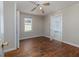Bedroom with hardwood floors, a window, and a door leading to the bathroom at 6296 Longino Drive, Union City, GA 30291