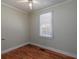 Cozy bedroom featuring hardwood floors, a window with blinds, and neutral walls at 6296 Longino Drive, Union City, GA 30291