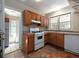 The kitchen features wood cabinets, white appliances, and a window over the sink at 6296 Longino Drive, Union City, GA 30291