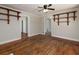Open living room with hardwood floors, decorative shelving, ceiling fan, and great natural light at 6296 Longino Drive, Union City, GA 30291