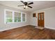Inviting living room featuring hardwood floors, a ceiling fan, and natural light from the windows at 6296 Longino Drive, Union City, GA 30291