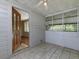 Bright sunroom featuring tile flooring, screened windows, and an inviting entry door at 6296 Longino Drive, Union City, GA 30291