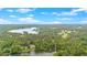 Aerial view showing lakeside community surrounded by mature trees offering a perfect blend of nature and modern living at 7370 N Mitchell Ct, Villa Rica, GA 30180