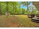 Large, private backyard surrounded by mature trees and featuring a charming wooden deck, perfect for outdoor relaxation at 7370 N Mitchell Ct, Villa Rica, GA 30180