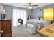 Comfortable bedroom featuring a ceiling fan, neutral colors and natural light at 7370 N Mitchell Ct, Villa Rica, GA 30180
