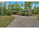 Charming home with well-maintained landscaping and a spacious driveway leading to a convenient carport at 7370 N Mitchell Ct, Villa Rica, GA 30180