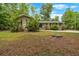 Charming one-story home with a well-manicured lawn and mature trees and a green front door at 7370 N Mitchell Ct, Villa Rica, GA 30180