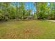 Spacious front yard with mature trees offering shade and privacy with a view of the house at 7370 N Mitchell Ct, Villa Rica, GA 30180