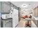 Bright kitchen features gray cabinets, white appliances, tiled floor and an open floor plan at 7370 N Mitchell Ct, Villa Rica, GA 30180